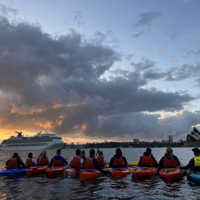 a group of people in a boat on a body of water