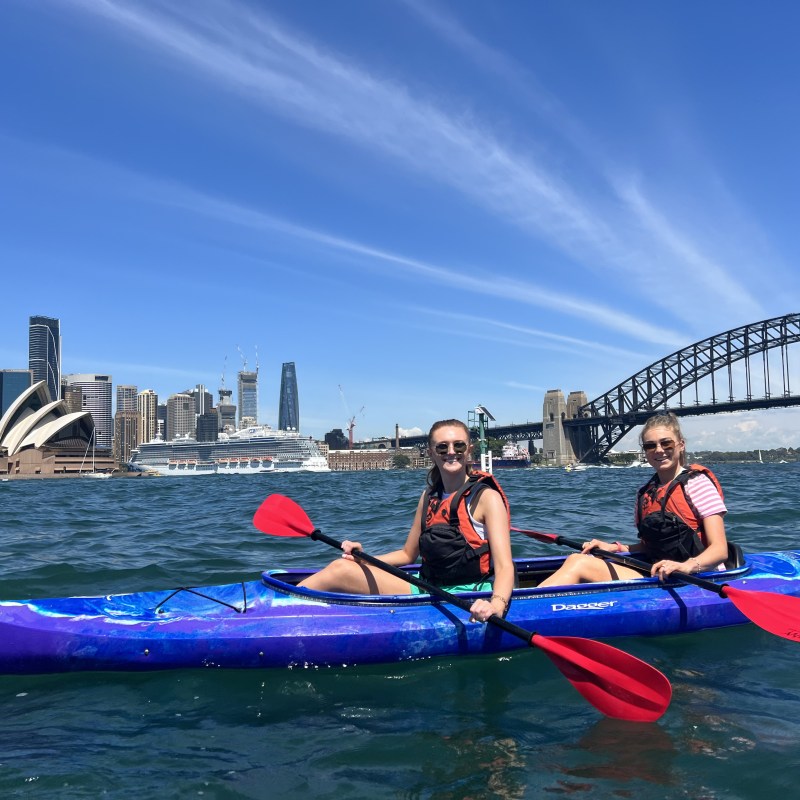 a group of people riding on the back of a boat in the water