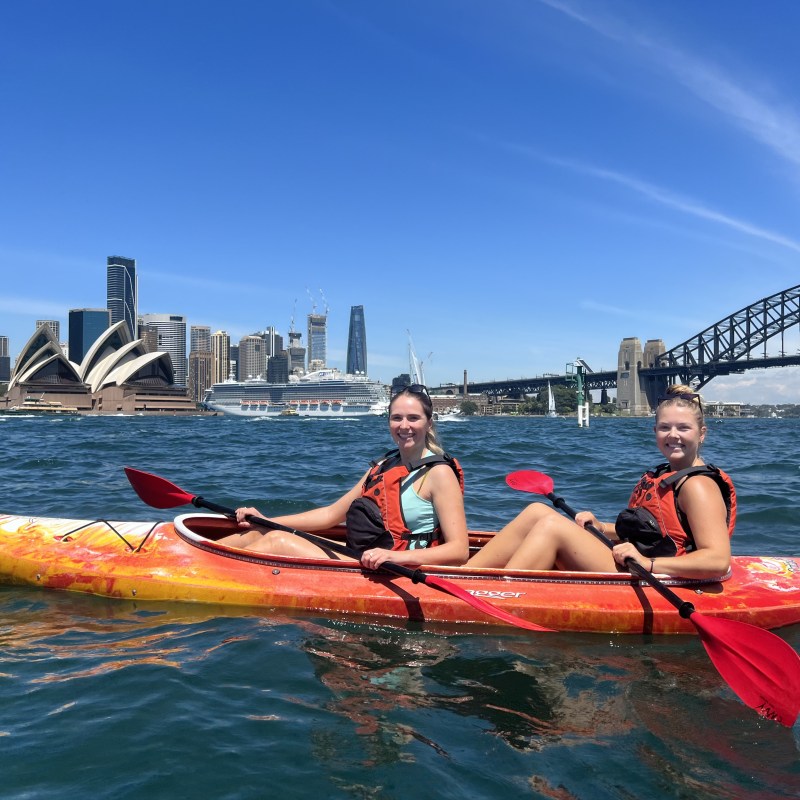 a group of people riding on the back of a boat in the water