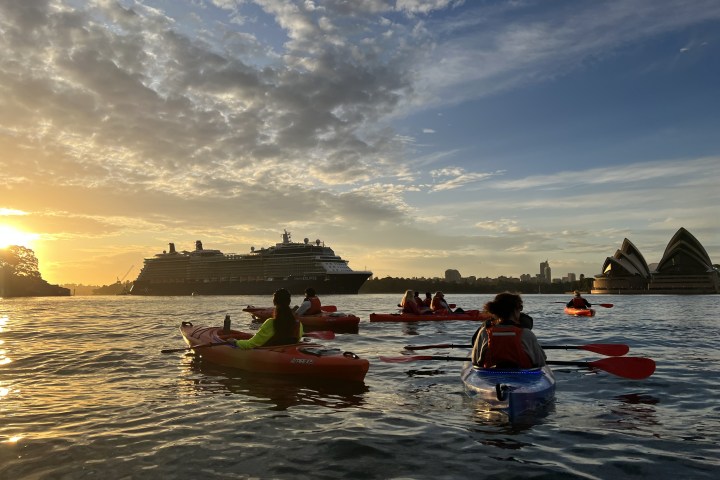 a group of people in a boat on a body of water