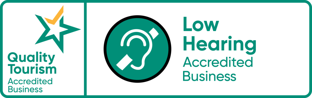Quality Tourism and Low Hearing Accredited Business logos on a rectangular banner.